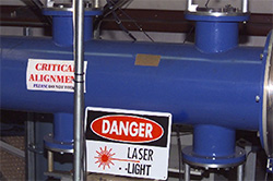 Measuring with Lasers: The horizontal blue tube in the image is the tube that the projectile passes through on it's way to the target. The pair of shorter vertical tubes are used to for the laser light screens with sensors on opposite side.
